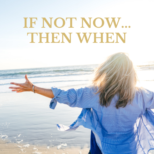 a woman standing on a beach with her arms out